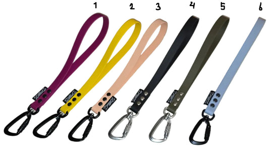 A display of six BioThane traffic handles numbered 1 to 6 in various colors, including purple, yellow, peach, black, olive, and light blue, shown with both black and silver carabiner options. In Sale